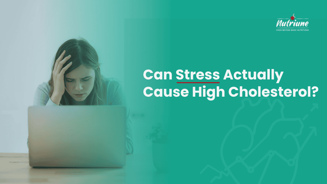 A stressed woman working on laptop illustrating how stress may cause high cholesterol