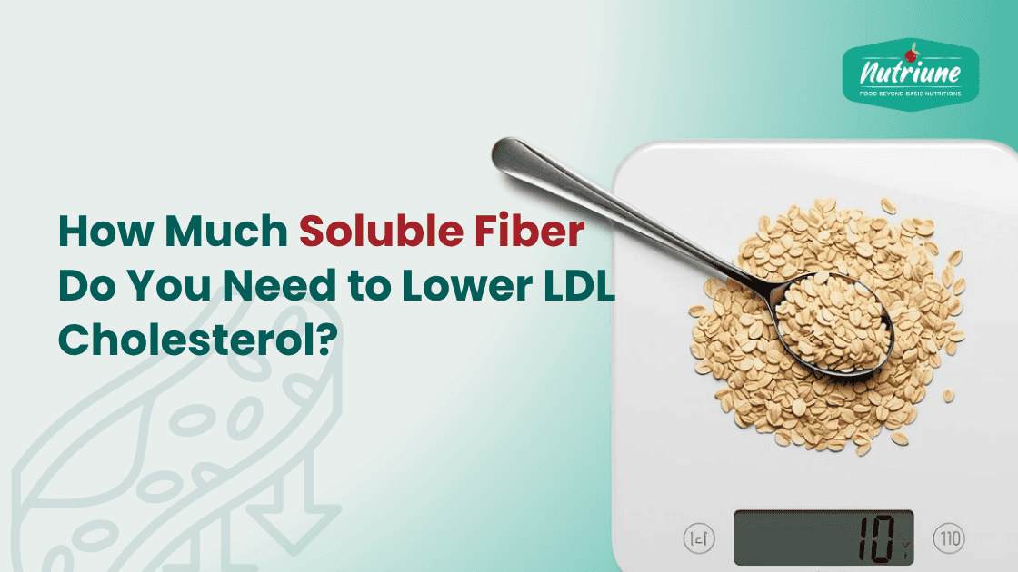 Spoon of oats on scale representing soluble fiber intake to lower LDL cholestero
